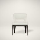Barilla Dining Chair featuring an off-white upholstered seat with a sleek cut-out backrest and dark wooden legs.