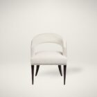 Charles Dining Chair, upholstered in a soft white velvet fabric with a curved backrest, nailhead trim, and tapered dark wood legs.