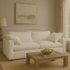 Plush white two-seat sofa with deep cushions, oversized arms, and a minimalist silhouette.