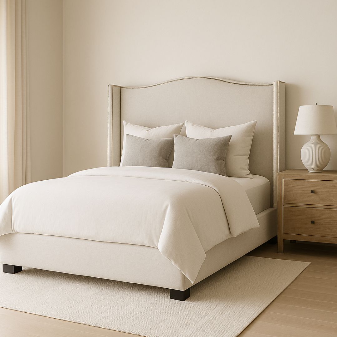 Elegant beige upholstered Layla Bed with curved headboard and minimalist bedroom styling.
