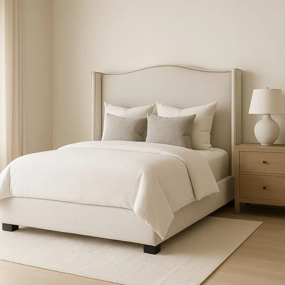 Elegant beige upholstered Layla Bed with curved headboard and minimalist bedroom styling.