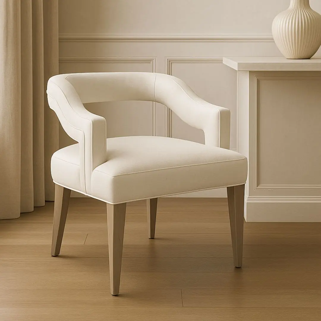 Elegant modern dining armchair with sculpted backrest and plush ivory upholstery, shown in both a lifestyle interior and isolated product view.