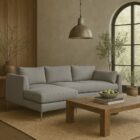 Modern grey sectional sofa with low back, slim arms, and metal tapered legs featuring a left-facing chaise
