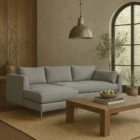Modern grey sectional sofa with low back, slim arms, and metal tapered legs featuring a left-facing chaise