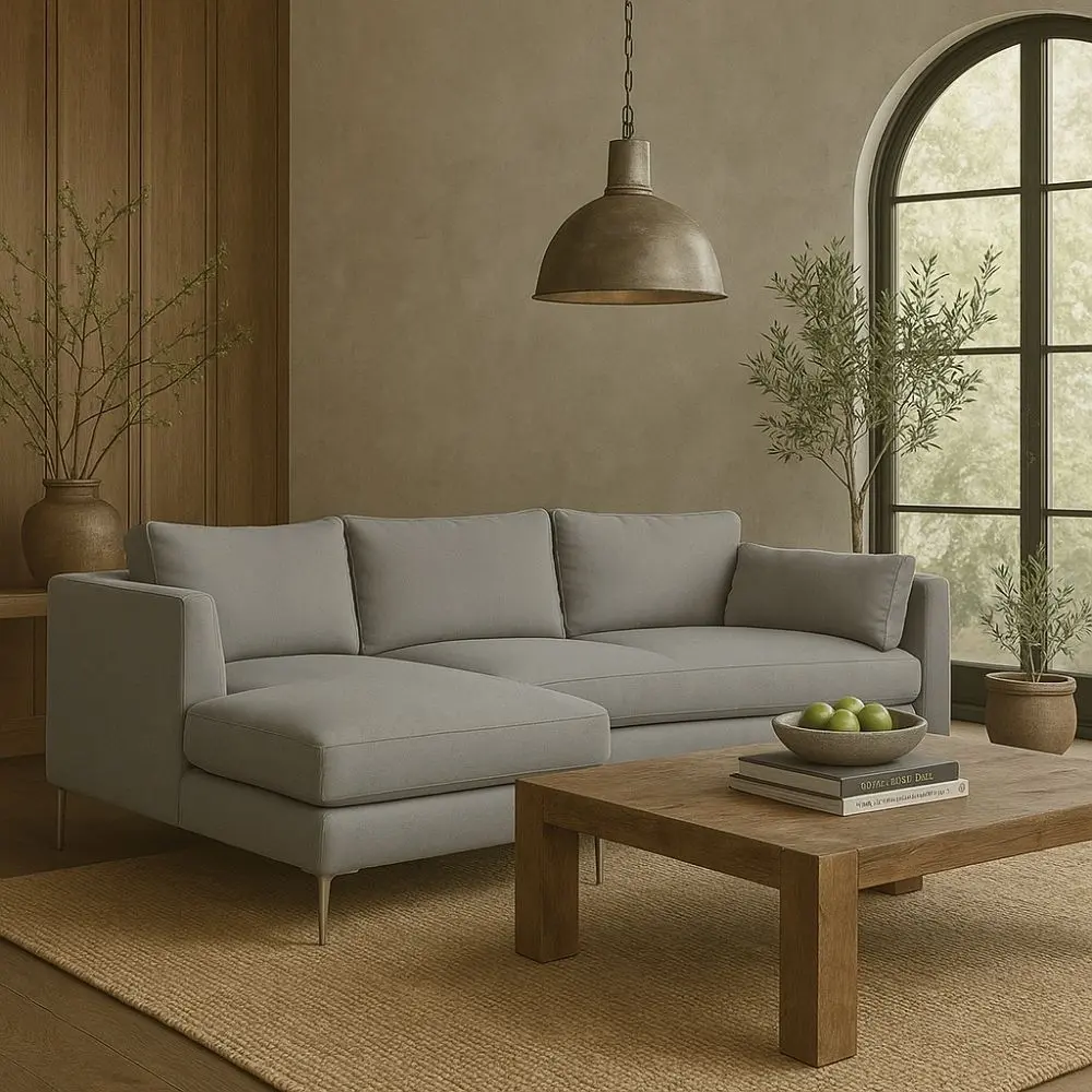 Modern grey sectional sofa with low back, slim arms, and metal tapered legs featuring a left-facing chaise
