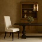 Rosen Dining Chair, featuring a high back, softly curved silhouette, and dark tapered legs with a smooth, ivory-toned upholstered seat.