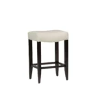 A backless upholstered saddle stool with cream fabric seat, dark espresso wood frame, and footrest support.