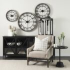 Black metal sideboard with four glass-front doors featuring X-cross detailing and slim tapered legs.