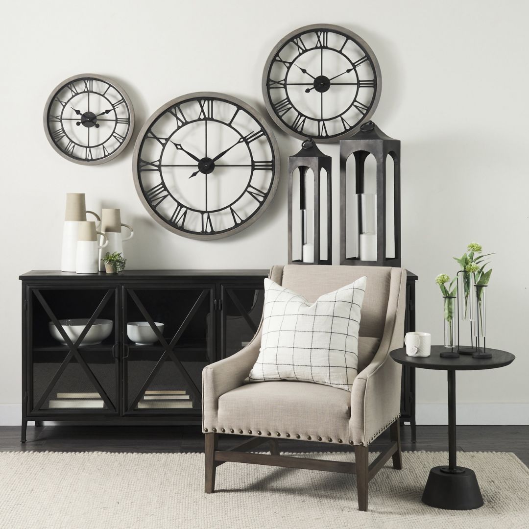 Black metal sideboard with four glass-front doors featuring X-cross detailing and slim tapered legs.
