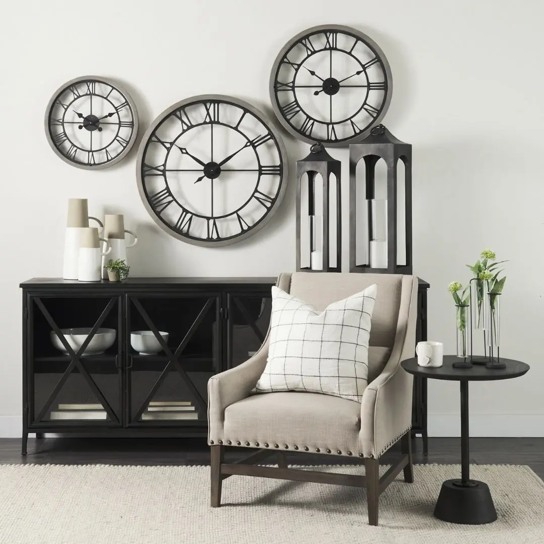 Black metal sideboard with four glass-front doors featuring X-cross detailing and slim tapered legs.