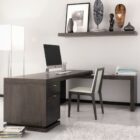 Dark wood L-shaped executive desk with integrated drawers and return credenza.