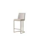A modern upholstered counter stool with a curved brass-finished metal base and light neutral fabric seat and back.