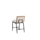 A modern upholstered counter stool with a soft cream fabric seat and backrest, wooden trim, and sleek black metal legs.