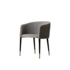 Modern barrel-back dining armchair with charcoal grey fabric seat, faux leather exterior, black tapered legs, and brass metal caps.