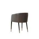 Modern barrel-back dining armchair with charcoal grey fabric seat, faux leather exterior, black tapered legs, and brass metal caps.