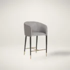 Asher counter stool with upholstered seat and backrest, black tapered legs, and gold foot caps.