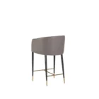 Asher counter stool with upholstered seat and backrest, black tapered legs, and gold foot caps.