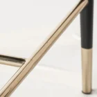 Asher counter stool with upholstered seat and backrest, black tapered legs, and gold foot caps.