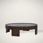Large round coffee table with dark wood finish and sculptural base design, featuring a recessed top.