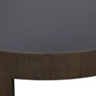 Large round coffee table with dark wood finish and sculptural base design, featuring a recessed top.