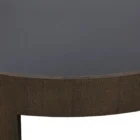 Large round coffee table with dark wood finish and sculptural base design, featuring a recessed top.