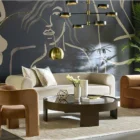 Large round coffee table with dark wood finish and sculptural base design, featuring a recessed top.