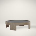 Round coffee table with light wood base and dark recessed top, featuring sculptural curved legs.