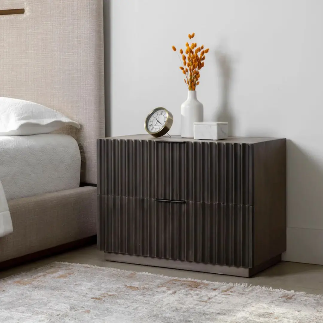 Dark wood nightstand with distinctive vertical fluted drawer fronts and a minimalist rectangular silhouette.