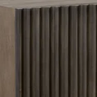 Large dark wood sideboard with vertical fluted front detailing and slim black legs, styled in a minimalist aesthetic.
