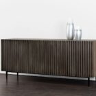 Large dark wood sideboard with vertical fluted front detailing and slim black legs, styled in a minimalist aesthetic.