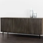 Large dark wood sideboard with vertical fluted front detailing and slim black legs, styled in a minimalist aesthetic.