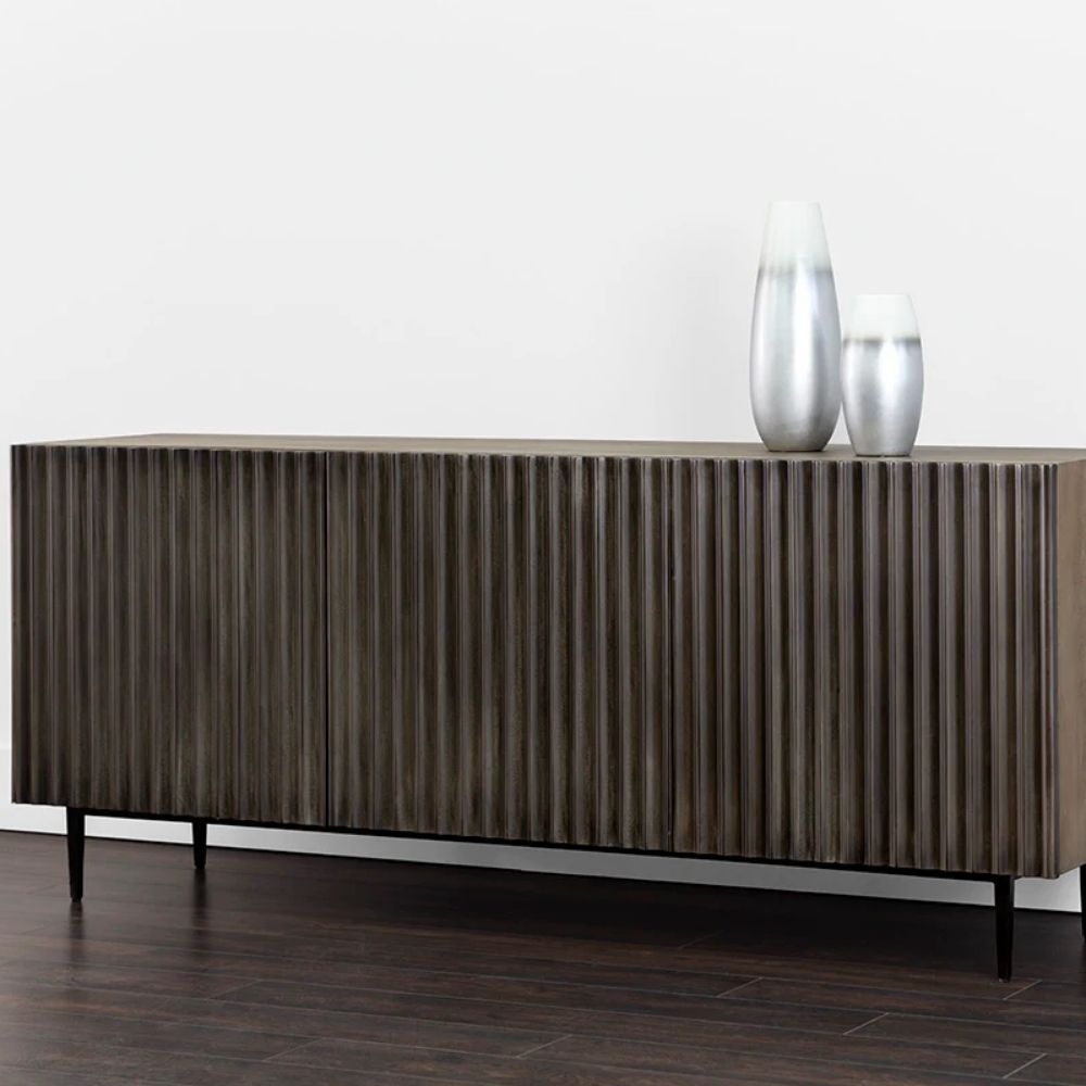 Large dark wood sideboard with vertical fluted front detailing and slim black legs, styled in a minimalist aesthetic.