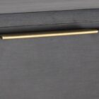 Dark wood dresser with six drawers, slim gold handles, and tapered gold legs.