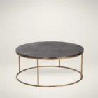 Round coffee table with a textured charcoal top and gold-finished metal base