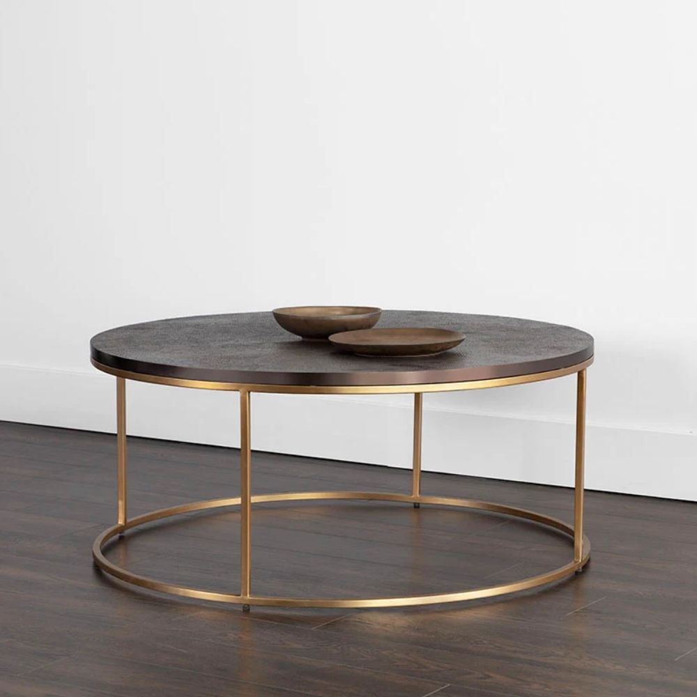 Round coffee table with a textured charcoal top and gold-finished metal base