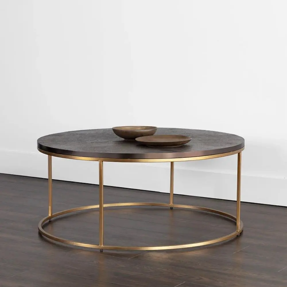 Round coffee table with a textured charcoal top and gold-finished metal base
