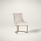 Elegant stool with soft beige upholstered seat and curved gold metal base.