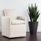 Glenrose Wheeled Dining Chair in a soft, ivory textured fabric with a boxed frame and recessed arms.