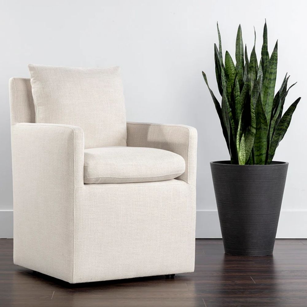 Glenrose Wheeled Dining Chair in a soft, ivory textured fabric with a boxed frame and recessed arms.