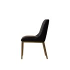 Black leather dining chair with vertical channel stitching, arched backrest, and slim brass-toned legs.