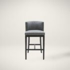 Dark grey upholstered barstool with low backrest and black wooden legs, styled beside a light wood countertop in a neutral-toned interior.