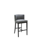 Dark grey upholstered barstool with low backrest and black wooden legs, styled beside a light wood countertop in a neutral-toned interior.