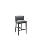 Dark grey upholstered barstool with low backrest and black wooden legs, styled beside a light wood countertop in a neutral-toned interior.