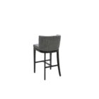 Dark grey upholstered barstool with low backrest and black wooden legs, styled beside a light wood countertop in a neutral-toned interior.