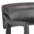 A modern barstool with black wood frame, dark leather upholstery, and a low backrest.