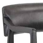 A modern barstool with black wood frame, dark leather upholstery, and a low backrest.