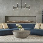 Small round concrete coffee table with a curved bowl-like base and smooth grey finish.