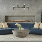 Small round concrete coffee table with a curved bowl-like base and smooth grey finish.