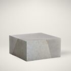 Square concrete coffee table with angular crack-inspired detail and softly weathered stone texture.