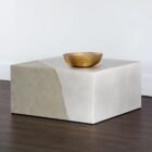 Square concrete coffee table with angular crack-inspired detail and softly weathered stone texture.